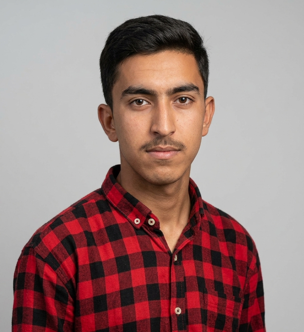 Scholarship winner in a red and black checked shirt, studio portrait