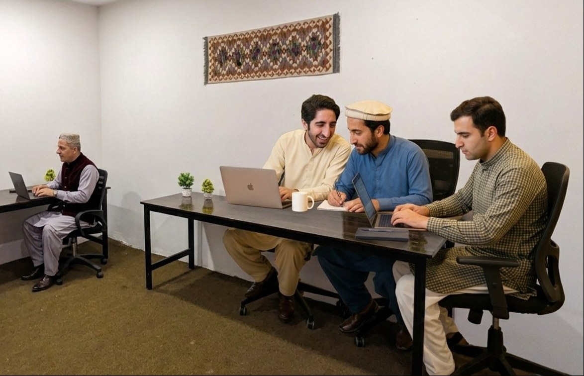 People working at laptops in the shared workspace at DOST Hub