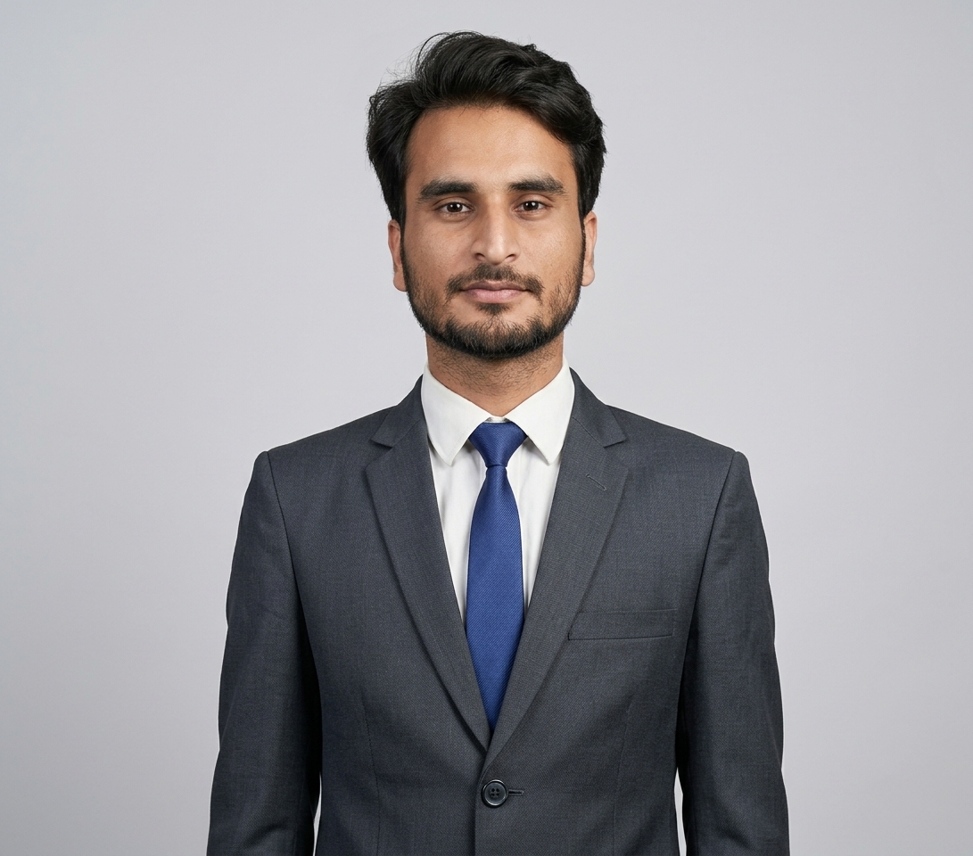 Scholarship winner in a dark suit and blue tie, studio portrait